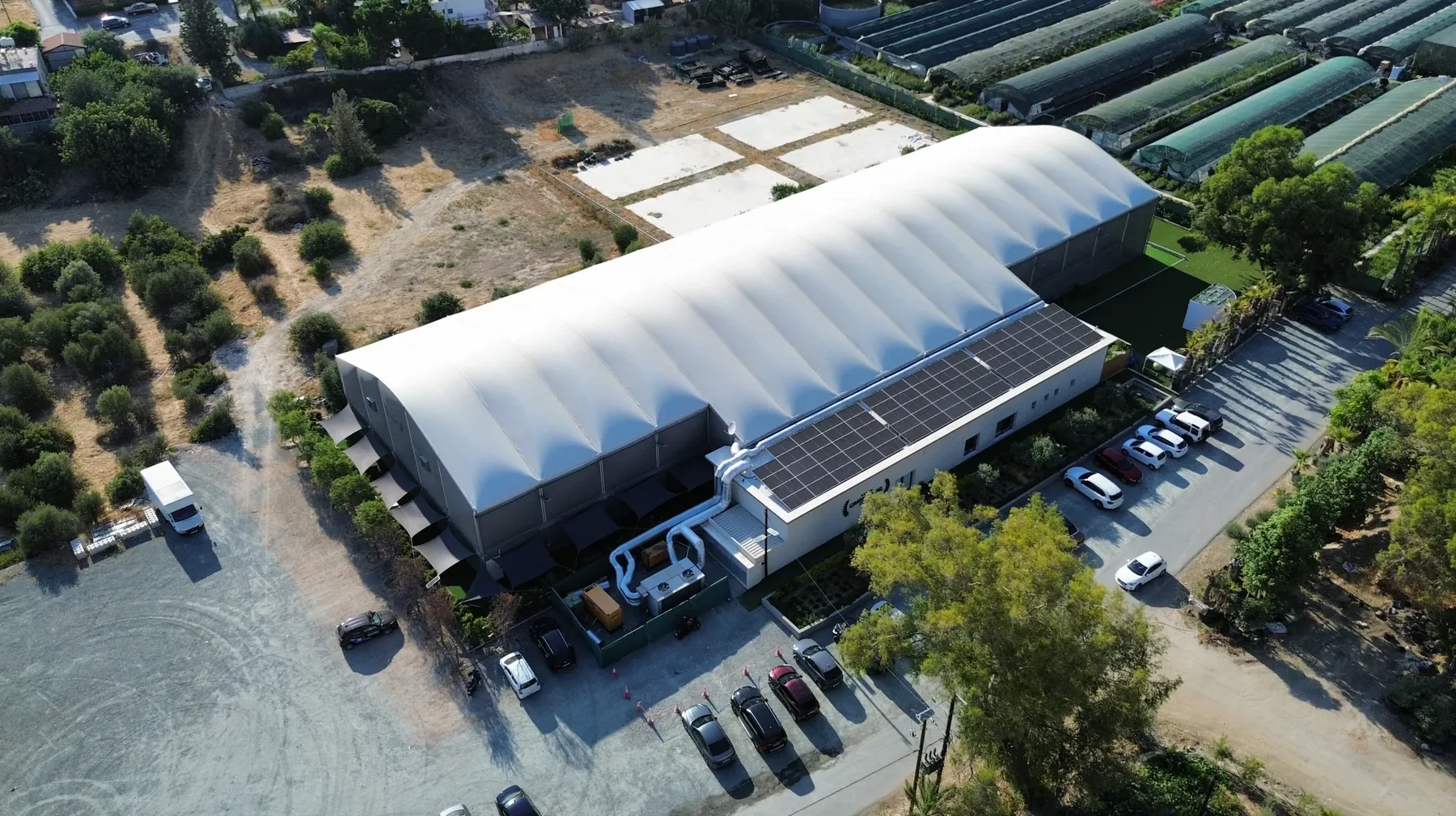 Aerial view of Green Padel Club, Limassol, with the solar array on the clubhouse roof